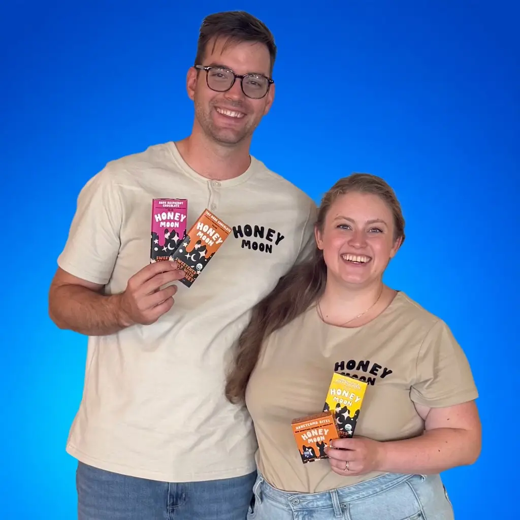 Cam and Haley Loyet, co-founders of Honeymoon Chocolates, holding chocolate bars